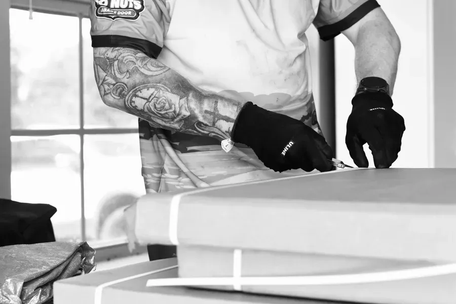 Go Nuts Garage Door technician repairing a garage door in Godley, TX
