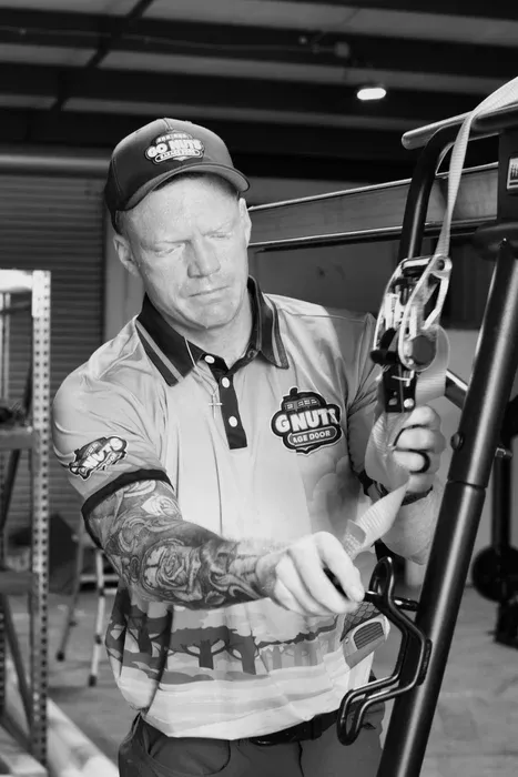 Go Nuts Garage Door technician repairing a garage door bottom seal in Granbury, TX