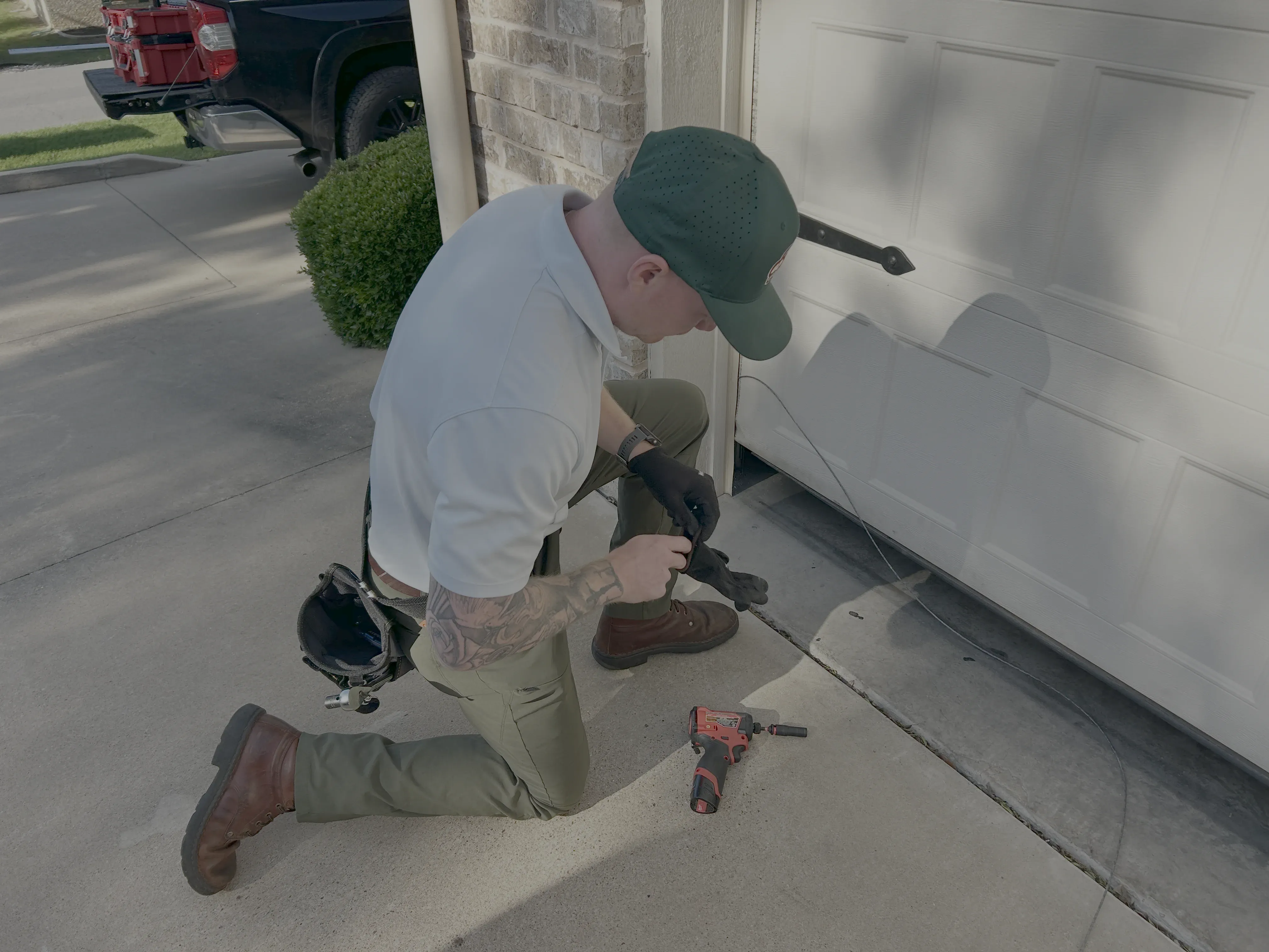 Go Nuts Garage Door technician repairing a garage door bottom seal in Granbury, TX