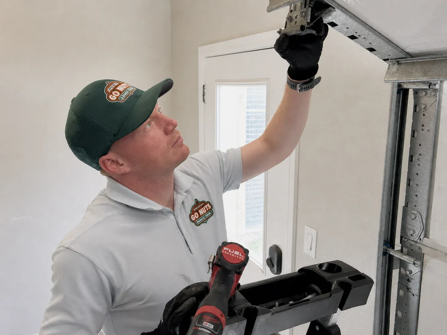 Go Nuts Garage Door technician installing a new garage door track in Granbury, TX