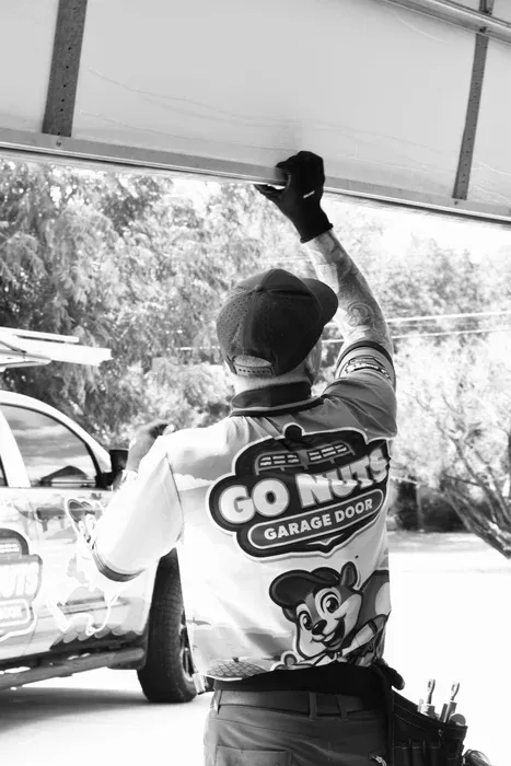 Go Nuts Garage Door technician repairing a garage door in Granbury, TX