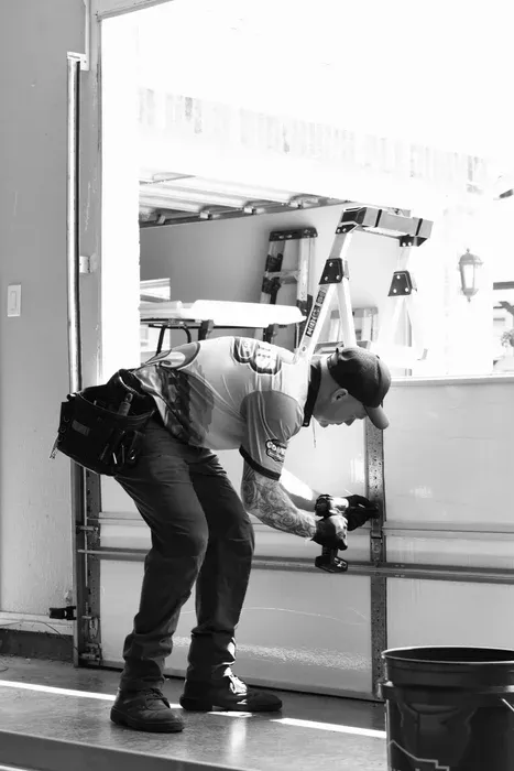 Go Nuts Garage Door technician servicing a garage door in Godley, TX
