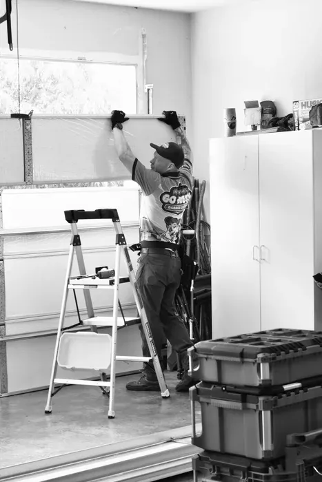 Go Nuts Garage Door technician inspecting a garage door panel in Willow Park, TX