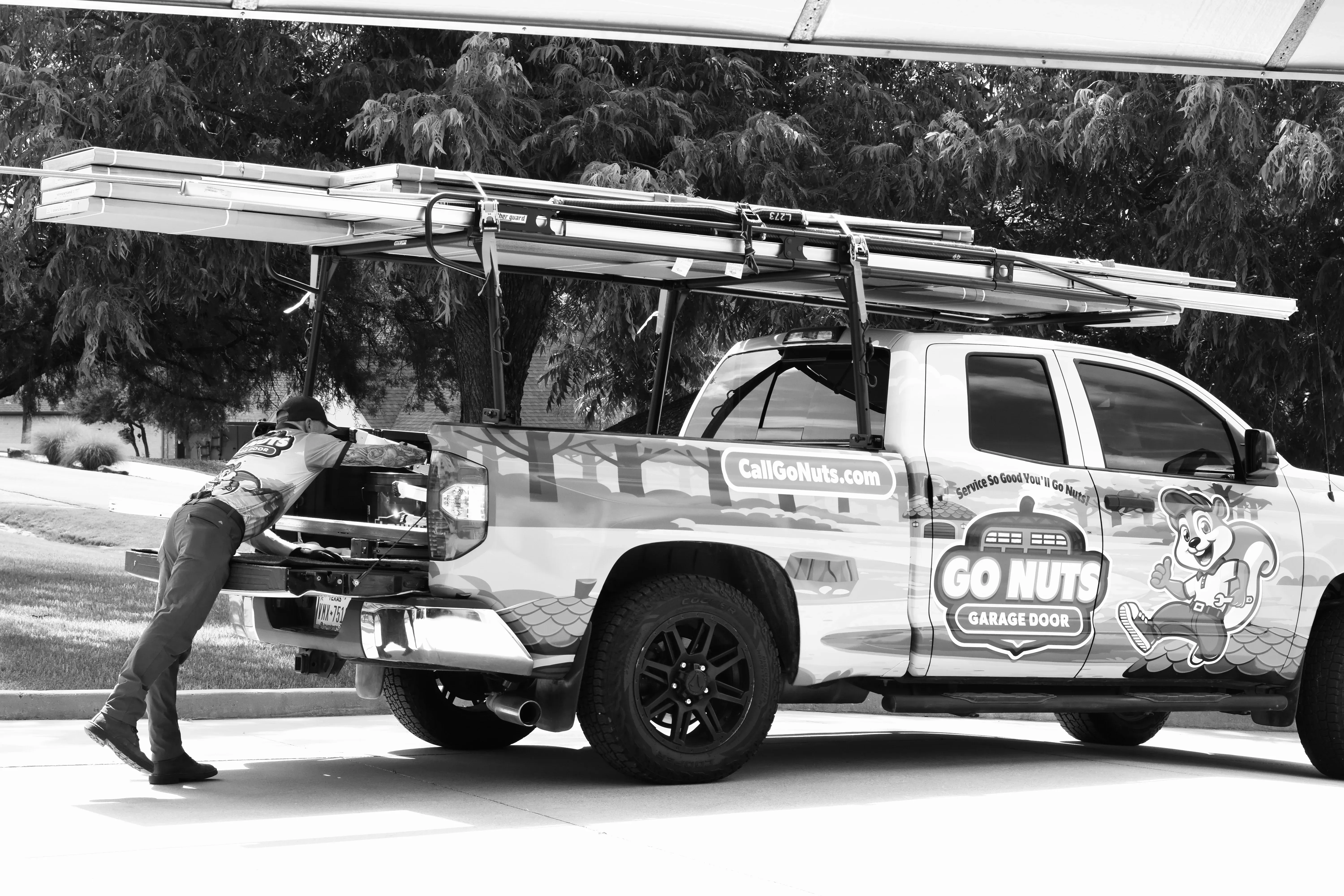 Go Nuts Garage Door technician repairing a garage door in Benbrook, TX