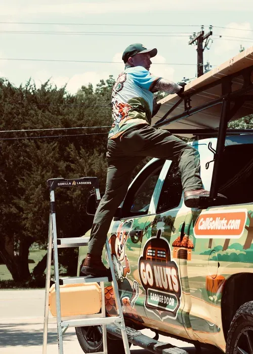 Go Nuts Garage Door technician installing a garage door opener in Godley, TX