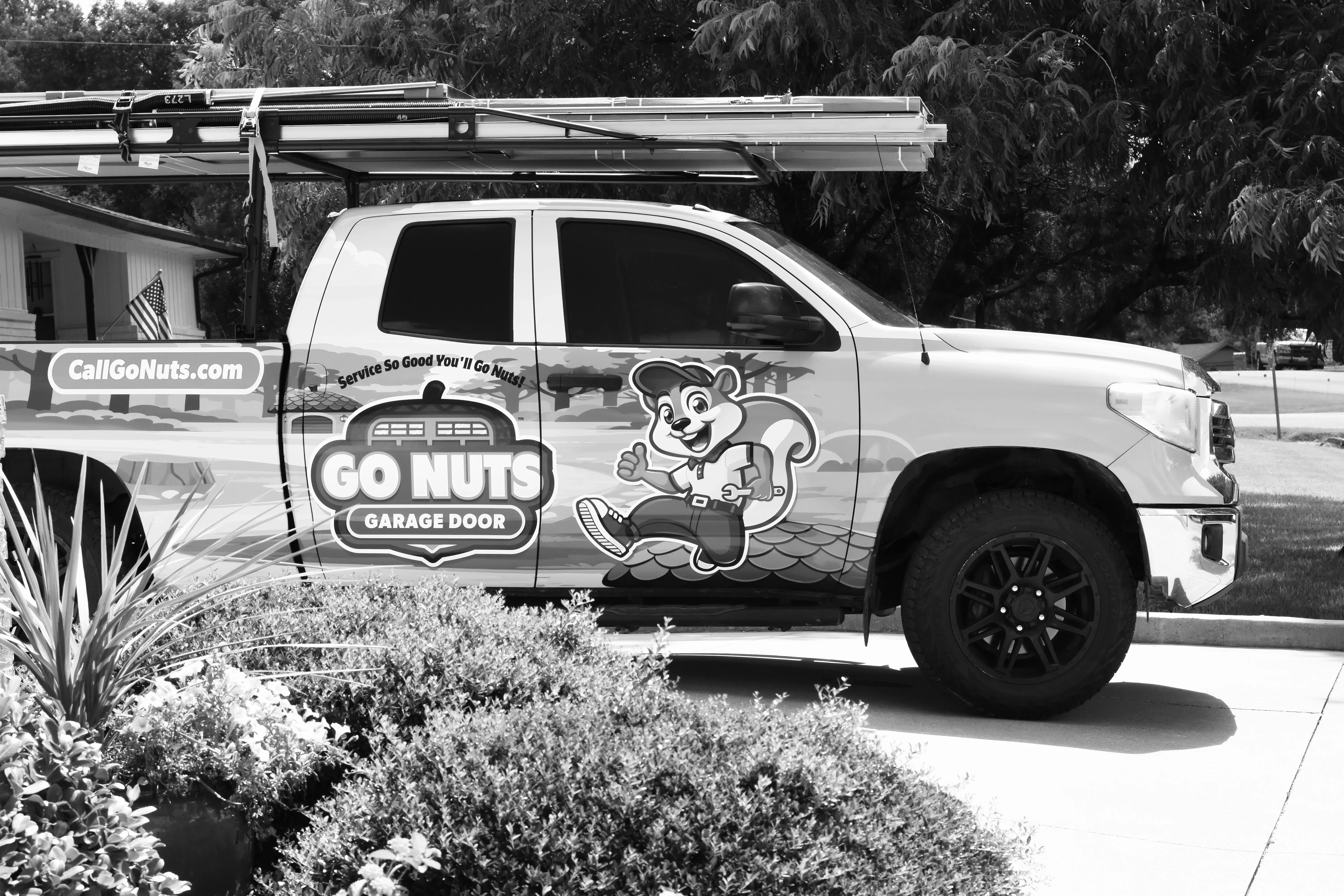 Go Nuts Garage Door technician inspecting a garage door panel in Aledo, TX