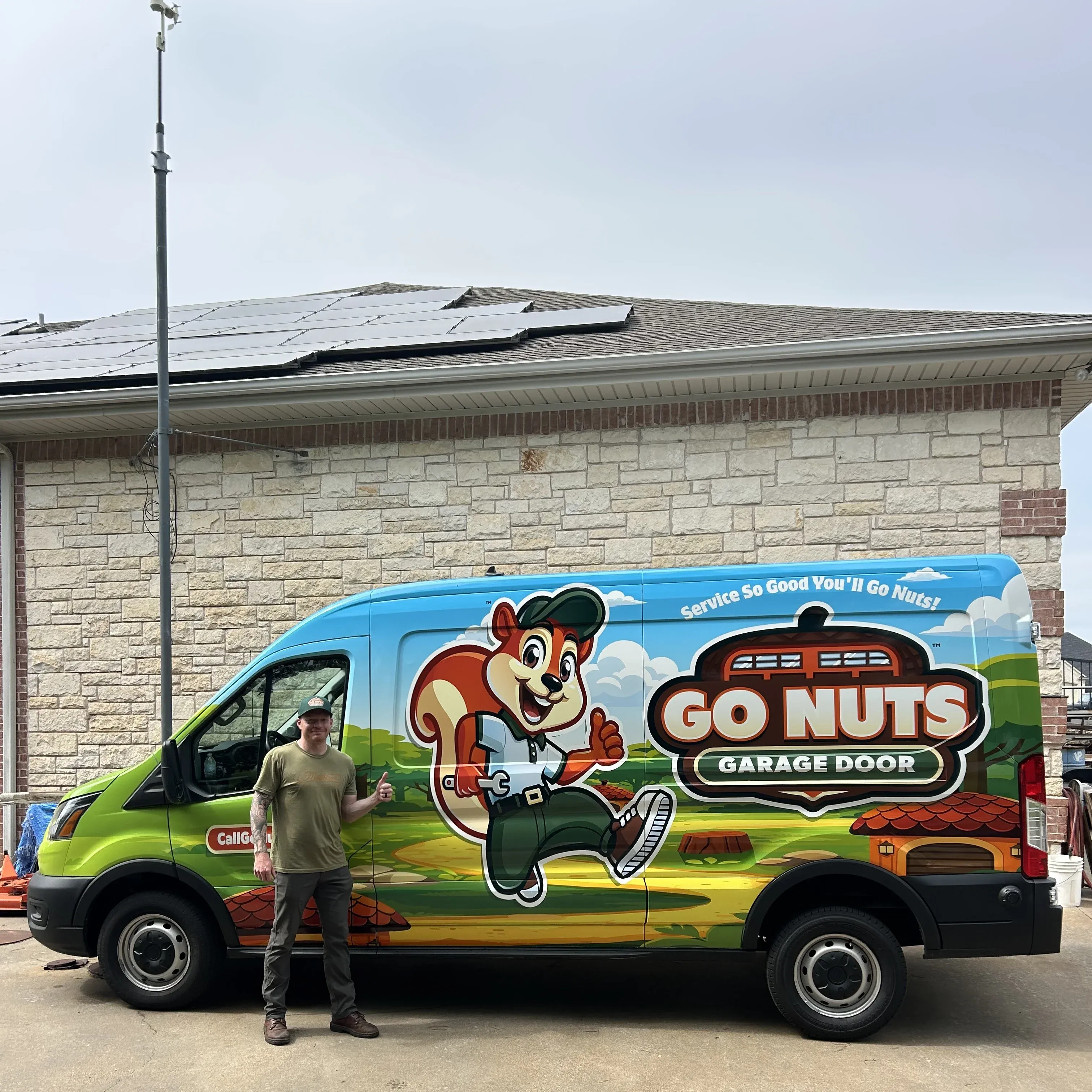 Trey Harless, owner of Go Nuts Garage Door, standing in front of the branded Go Nuts service van in Granbury, TX